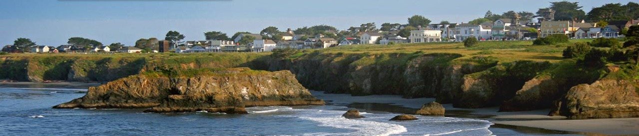 The Mendocino coastline — headlands, beach and the village above the bluffs